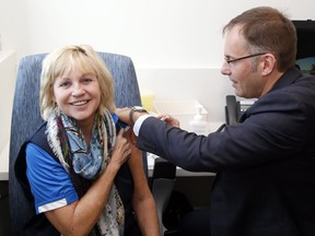 Quinte West Coun. Karen Sharpe receives a flu shot in 2018 from then-medical officer of health Dr. Piotr Oglaza at Hastings Prince Edward Public Health's Belleville office.