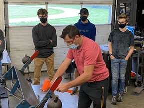 St. Marys DCVI manufacturing and technology teacher Chris Huber shows his students how to create ductwork fittings that will be used in the construction of a Guelph condo building. (Submitted photo)