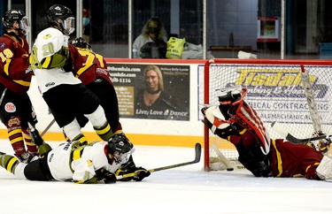 Even though he was laying down on the ice, Powassan Voodoos forward Jackson Buffam managed to slip the puck past Rock goalie Gavin McCarthy, who had been knocked flat on his back moments earlier, and into the Timmins net during the second period of Sunday afternoon’s NOJHL contest at the McIntyre Arena. The goal gave the Voodoos a 3-1 lead in a game they would go on to win 4-3. THOMAS PERRY/THE DAILY PRESS