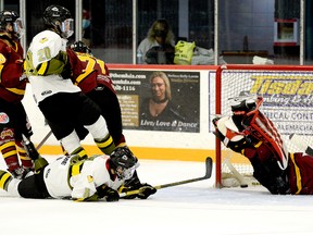 Even though he was laying down on the ice, Powassan Voodoos forward Jackson Buffam managed to slip the puck past Rock goalie Gavin McCarthy, who had been knocked flat on his back moments earlier, and into the Timmins net during the second period of Sunday afternoon’s NOJHL contest at the McIntyre Arena. The goal gave the Voodoos a 3-1 lead in a game they would go on to win 4-3. THOMAS PERRY/THE DAILY PRESS