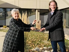 Strathcona-Sherwood Park MLA Nate Glubish (right) presents Judy Ferguson, executive director of the Volunteer Strathcona Centre, with a Minister’s Seniors Service Award. Linking Generations Society was also honoured in the same award category on Thursday, Oct. 21. Photo courtesy Facebook/Volunteer Strathcona