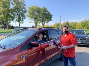 Chris Swarthout, a member of The Kinsmen Club of St. Marys, hands out a fire extinguisher during the local fire department’s first Cindy’s Law Fire Extinguisher Giveaway earlier this month. (Contributed photo)