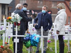 Discussing ways to address the opioid crisis at the Crosses for Change site at Brady and Paris on Sunday are, from left, Sudbury psychiatrist Rayudu Koka, Ontario Medical Association president Adam Kassam, OMA chief executive officer Allan O’Dette, and Denise Sandul, who initiated the memorial site after losing her son Myles to an overdose.