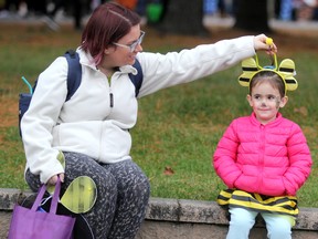 Keara Gelinas adjusts the bumblebee costume of her daughter, Parker Gelinas, 3, during trick or treating at Algoma University in Sault Ste. Marie, Ont., on Wednesday, Oct. 30, 2019. (BRIAN KELLY/THE SAULT STAR/POSTMEDIA NETWORK)