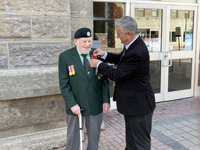 Brockville Mayor Mike Kalivas pins first poppy on veteran Ted Hughes. Wayne Lowrie/Recorder and Times