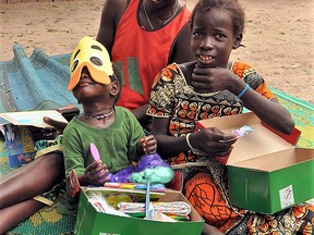 Children in Senegal checking out the contents of their Canadian-packed Operation Christmas Child shoeboxes. (supplied photo)