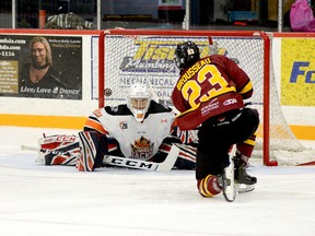 Timmins Rock forward Riley Brousseau goes down to one knee as he lifts the puck up and over Hearst Lumberjacks goalie Matteo Gennaro during the first period of Friday night’s NOJHL contest at the McIntyre Arena. Brousseau finished the contest with two goals as the Rock held on to edge the Lumberjacks 4-3. The Rock will return to action on Friday when they host the Cochrane Crunch at the McIntyre Arena, at 7:30 p.m. THOMAS PERRY/THE DAILY PRESS