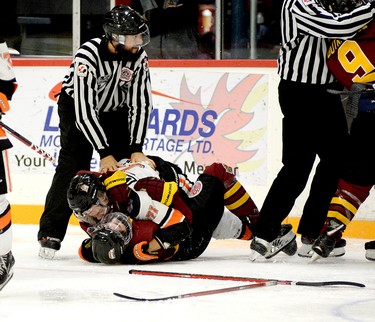 Timmins Rock forward Henry Brock, bottom, and Hearst Lumberjack forward Raphael Lajeunesse wrestle during a second-period scrum in Friday night’s NOJHL game at the McIntyre Arena. Each team was assessed 27 minutes in penalties in the contest that saw the Rock hang on to edge the Lumberjacks 4-3. THOMAS PERRY/THE DAILY PRESS