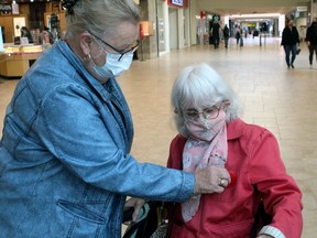 Diane Roy pins a poppy on Colette Stewart's jacket, Friday, at Northgate Shopping Centre. The annual Royal Canadian Legion Poppy Campaign kicked off Friday and runs until Nov. 10.
PJ Wilson/The Nugget