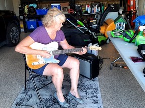 Once the CEO of the Huron-Perth Centre for Children and Youth, Terri Sparling is preparing to rock out on an electric guitar built by a former colleague as one of more than a dozen acts in the Avondale United Church variety show, Avondale Connections, on Nov. 5. Pictured, Sparling rehearses on the guitar in her garage. (Submitted photo)