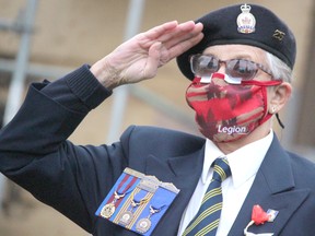 Helen Stewart, president of Royal Canadian Legion Branch 25, salutes during the launch of the poppy campaign at the cenotpah on Queen Street East on Friday morning. BRIAN KELLY