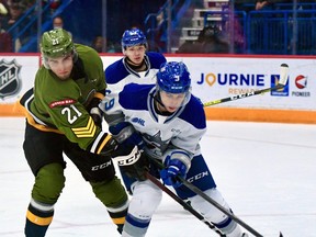Brandon Coe of the North Bay Battalion battles Alex Assadourian of the Sudbury Wolves for position in Ontario Hockey League action Sunday. The Troops played the second of six straight games on the road.
Sean Ryan Photo