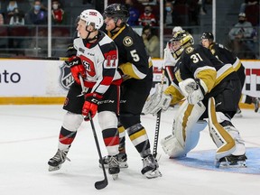 Ottawa 67’s forward Brady Stonehouse, left, battles Kingston Frontenacs’ Braden Hache in front of goalie Leevi Merilainen at TD Place in Ottawa on Oct. 10, 2021. (Valerie Wutti/Blitzen Photography)