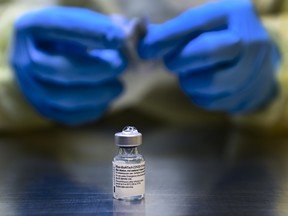 A health-care worker prepares a dose of the Pfizer-BioNTech COVID-19 vaccine at a UHN COVID-19 vaccine clinic in Toronto on Thursday, January 7, 2021. THE CANADIAN PRESS/Nathan Denette