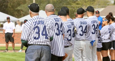 Descendants of the 1934 Chatham Colored All-Stars stand on the baselines after playing a slo-pitch game at Fergie Jenkins Field at Rotary Park in Chatham, Ont., on Saturday, Oct. 2, 2021. Mark Malone/Chatham Daily News/Postmedia Network