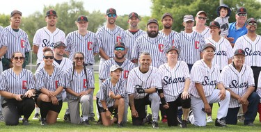 Descendants of the 1934 Chatham Colored All-Stars gather for a group photo after playing a slo-pitch game at Fergie Jenkins Field at Rotary Park in Chatham, Ont., on Saturday, Oct. 2, 2021. Mark Malone/Chatham Daily News/Postmedia Network