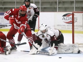 Chatham Maroons goalie Brenden Stroble reaches for the puck after making a save against Leamington Flyers' Darby Lemieux in the third period at Chatham Memorial Arena in Chatham, Ont., on Saturday, Oct. 9, 2021. Mark Malone/Chatham Daily News/Postmedia Network