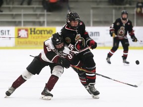 Sarnia Legionnaires' Brayden DeGelas, right, is checked by Chatham Maroons' David Brown in the third period at Chatham Memorial Arena in Chatham, Ont., on Sunday, Oct. 10, 2021. Mark Malone/Chatham Daily News/Postmedia Network