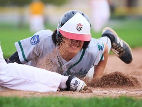 Vaughn Maginn of the St. Patrick's Fighting Irish dives back to first base on a pickoff attempt by the CKSS Golden Hawks during their LKSSAA baseball regular-season finale at Fergie Jenkins Field at Rotary Park in Chatham, Ont., on Thursday, Oct. 14, 2021. Mark Malone/Chatham Daily News/Postmedia Network