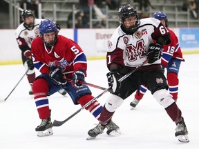 Chatham Maroons' Bhrett Hibbert (61) is checked by Strathroy Rockets' Owen Kindree (5) in the first period at Chatham Memorial Arena in Chatham, Ont., on Sunday, Oct. 24, 2021. Mark Malone/Chatham Daily News/Postmedia Network