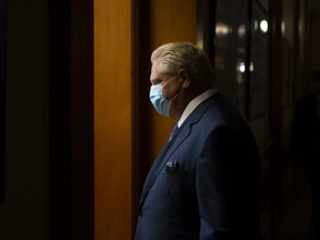 Ontario Premier Doug Ford returns to his office following a press briefing at the Queens Park Legislature in Toronto on Friday, October 15, 2021.