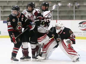 Chatham Maroons' Cameron Symons (16) and Cameron Welch (51) battle Sarnia Legionnaires' Reed Stauffer (12) in front of Legionnaires goalie Nolan DeKoning in the second period at Chatham Memorial Arena in Chatham, Ont., on Sunday, Oct. 10, 2021. Mark Malone/Chatham Daily News/Postmedia Network