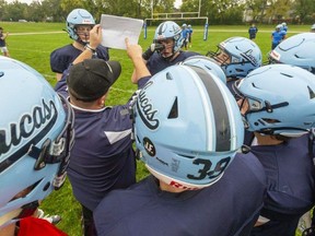 Offensive coordinator Gary Gerard lays out the play for the Lucas offence during practice at A.B. Lucas Secondary School in London The season kicks off this week for sports across the public and Catholic school boards. Mike Hensen/The London Free Press