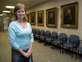 Shawna Lewkowitz, the founder of Women and Politics, stands in a hall in London's city hall that features several portraits of former mayors in London on Wednesday, July 23, 2014. The group announced Tuesday on its website that it is wind down Dec. 31. London Free Press file photo