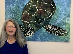 Catherine Petch with her art quilt. She's president of the Bluewater Quilters' Guild, which is offering students free guild memberships. (Brian Petch photo)