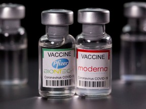 Vials with Pfizer-BioNTech and Moderna coronavirus disease (COVID-19) vaccine labels.