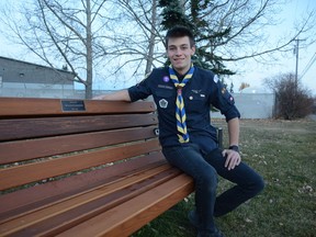 Austin Yeoman sits on the bench at East Lake Park that acknowledges the site of the former 2nd Airdrie Scouts Community Hall. Yeoman raised $2,500 with the support from the Scouts to make the bench a permanent fixture for his Capstone Project, ultimately earning the Queen Venturer Award.