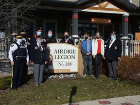 The Legion joins RCMP detachment commander Lauren Weare, fire chief Kevin Weinberger, Mayor Peter Brown, MLA Angela Pitt's representative Ben Widish, and City of Airdrie councillor Tina Petrow infront of Legion Branch 288 to celebrate the start of the annual Poppy Drive on October 28.