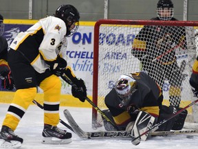 Zack Siemon-Hergott (3) of the Mitchell U15 hockey team reaches for a loose puck in the Huron-Bruce crease during WOAA regular season action Oct. 26 in Mitchell. The Meteors lost, 3-1. ANDY BADER/MITCHELL ADVOCATE