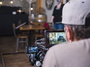 ictor Cooper, Co-owner of Eighty Twenty studio and director for Stoney Lonesome, looks through a camera's screen as he assesses the next scene the crew is about to film Thursday, in Belleville, Ontario. ALEX FILIPE