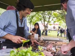 Joaquim Conde carves up freshly cooked meat Saturday at Quinta do Conde farm's Harvest-Tasting Festival held in Prince Edward County, Ontario. ALEX FILIPE