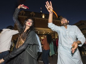 Diwali revellers dance together Sunday in Belleville, Ontario. ALEX FILIPE