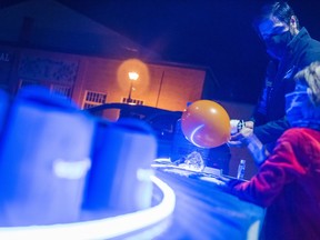 Peter Young, marketing and fundraising administration assistant for META employment services, fills a balloon with helium for a child attending their National Disability Employment Awareness Month event in Market square Thursday in Belleville, Ontario. ALEX FILIPE