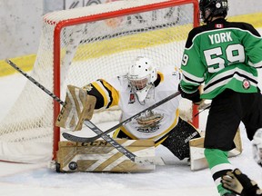 Trenton Golden Hawks William Nguyen makes a save as Cobourg Cougars' Tai York looks for a rebound during the Golden Hawks' 7-5 win Monday in Cobourg. SHAWN MUIR/OJHL IMAGES