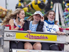 High school students (from left) Isla Kelly of Holy Trinity; and Emma Bradacs and Brie Smith of Simcoe Composite School enjoy a ride on the Scrambler on opening day of the 181st annual Norfolk County Fair in Simcoe on Tuesday October 5, 2021. Brian Thompson/Brantford Expositor/Postmedia Network