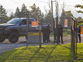 A Brantford Police supervisor speaks with Six Nations land defenders who began an occupation of the former Arrowdale Golf Course in Brantford, Ontario on Saturday.