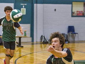 Ronan Vezsenyi of  St. John's College dives to bump the ball during a senior boys volleyball match against Paris District High School on Oct. 12.