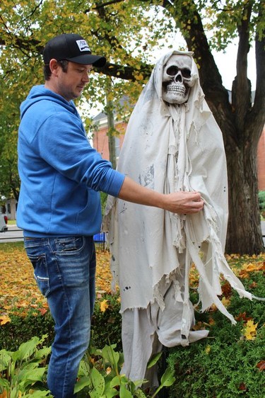 Chase Hunter puts the finishing touches on a circle of ghosts haunting the front of his Main Street home in celebration of the 39th annual Waterford Pumpkinfest. Michelle Ruby