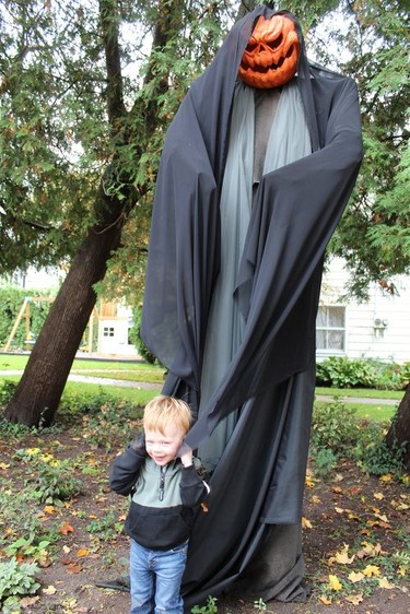 Two-year-old Brier Hunter doesn't seem at all frightened by the creepy monster decorating the property at his Main Street home. Michelle Ruby