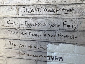 The words of the homeless population in downtown Brantford can be found on the wall of a covered porch of a former dental office at Market and Nelson streets.
