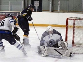 St. George Ravens player Lucas Felicetti and goalie Marek Pavlas keep their eye on the puck during a recent Greater Metro Junior A Hockey League game against Niagara at South Dumfries Community Centre.