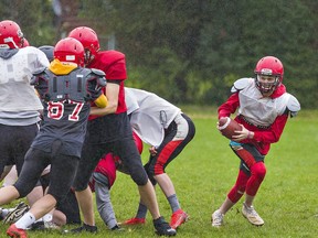 Quarterback Luke Rathbone of Paris District High School rolls out with the ball during a practice this week.