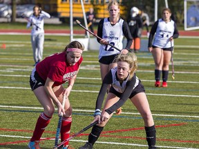 Mureea Montour (left) of Hagersville Secondary School and Victoria Cheney of Assumption College vie for the ball during a field hockey game this week at Kiwanis Field in Brantford.