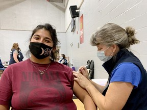 Julia Bremner, left, gets her first dose of COVID-19 vaccine from public health nurse Erin McLean at a Leeds, Grenville and Lanark District Health Unit pop-up clinic at the Brockville YMCA facility on Wednesday. (RONALD ZAJAC/The Recorder and Times)