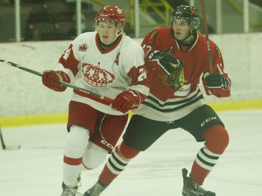 Jesse Kirkby (left) of the Lumber Kings and Owen Rainey of the Braves interact early in the Pembroke-Brockville game on Friday night. Kirkby went on to score an empty-netter for the visitors late in the third period to make the final 4-2 for the Lumber Kings.
Tim Ruhnke/The Recorder and Times