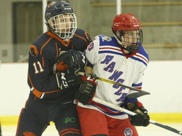 Caleb Smith (left) of Clarence shadows Zach White of South Grenville in front of the Castors net during NCJHL action in Cardinal on Saturday night.
Tim Ruhnke/The Recorder and Times